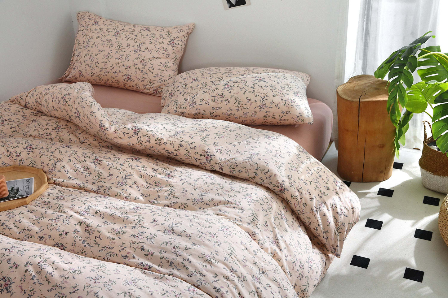 Pink beige duvet cover set with vintage floral print on bed.
