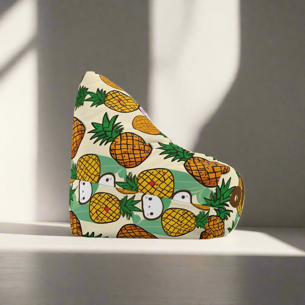 A triangular-shaped bean bag cover with a retro sunrise design featuring pineapples and cute characters, placed in a room setting.