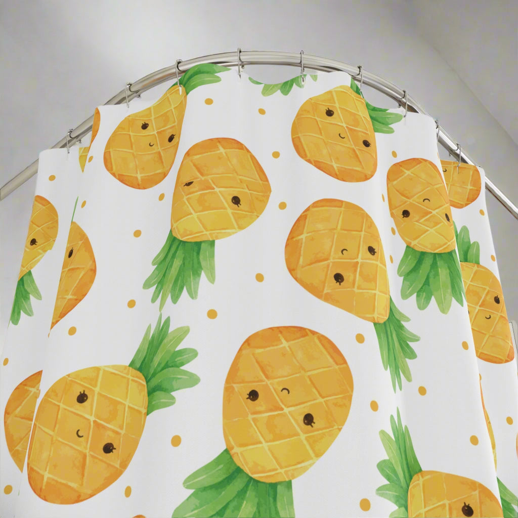A shower curtain featuring a cute pineapple theme with colorful pineapple designs on a white background, displayed in a bathroom setting.