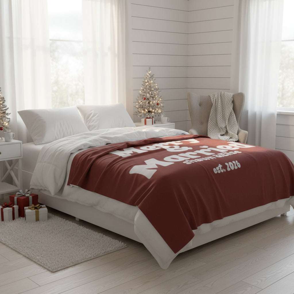 Personalized Christmas blanket in red with "Merry & Married" retro white text, custom couple names and year, perfect newlywed gift