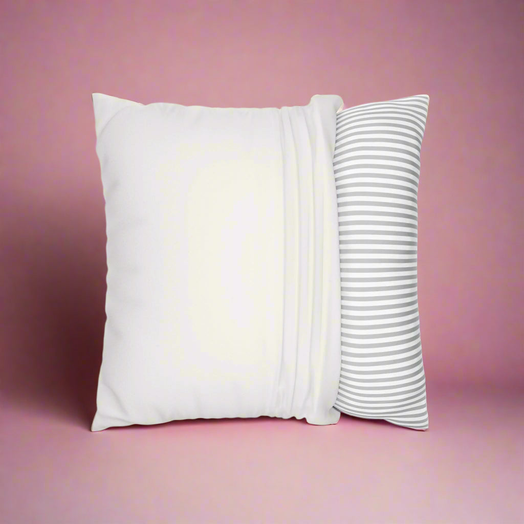 Two pillows, one plain white and one with a striped pattern, on a white background.