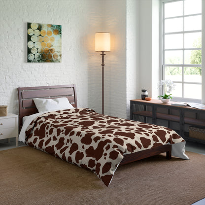 Cow Print Cozy Dorm Comforter in a soft aesthetic dorm room — soft natural lighting, warm layered styling by HomeStylesPlus