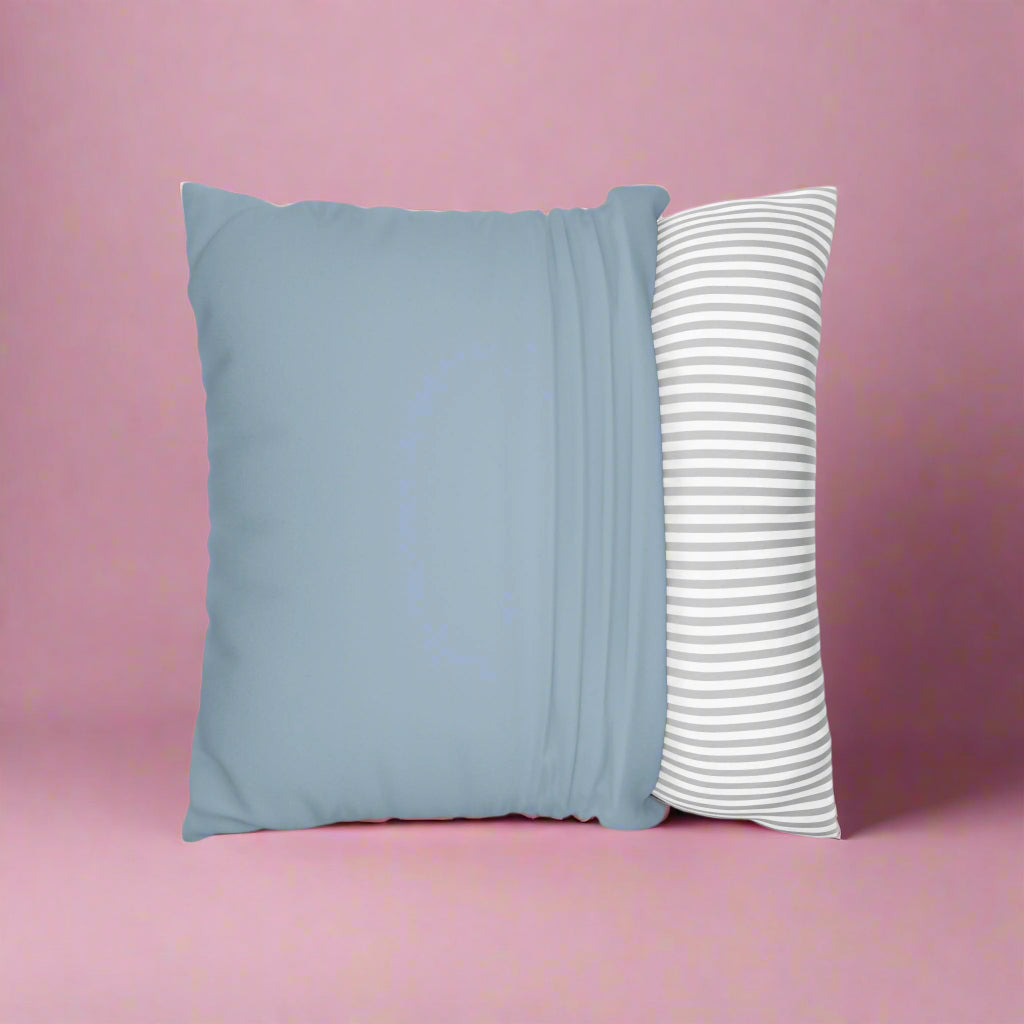 Light blue pillow with a striped white and gray pillow on a white background