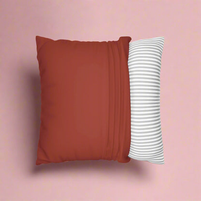 Red pillow and striped white pillow on a white background