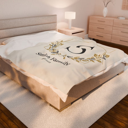 Personalized Family Monogram fleece blanket with custom names and elegant gold wreath design on a cozy bed throw for couples' anniversary or wedding gift