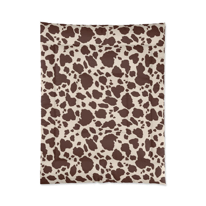 Cow Print Cozy Dorm Comforter in a soft aesthetic dorm room — soft natural lighting, warm layered styling by HomeStylesPlus