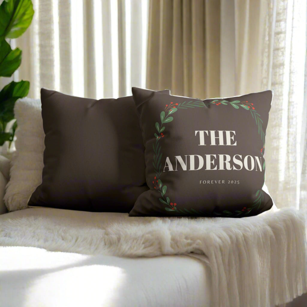 Decorative pillow with 'The Anderson Forever 2025' text on a gray sofa.