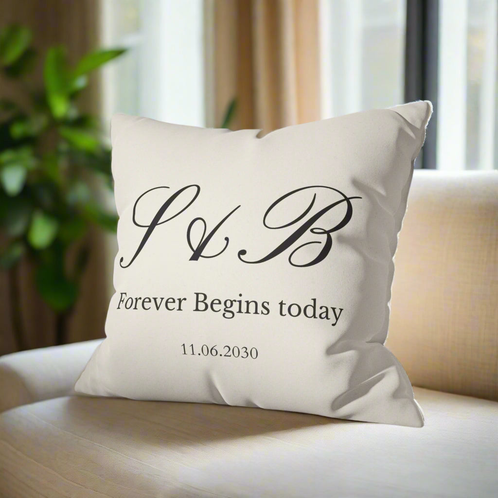 Decorative pillow with initials and text on a gray couch