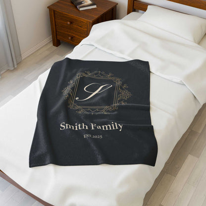 Personalized couples fleece throw blanket with monogram and family name on bed
