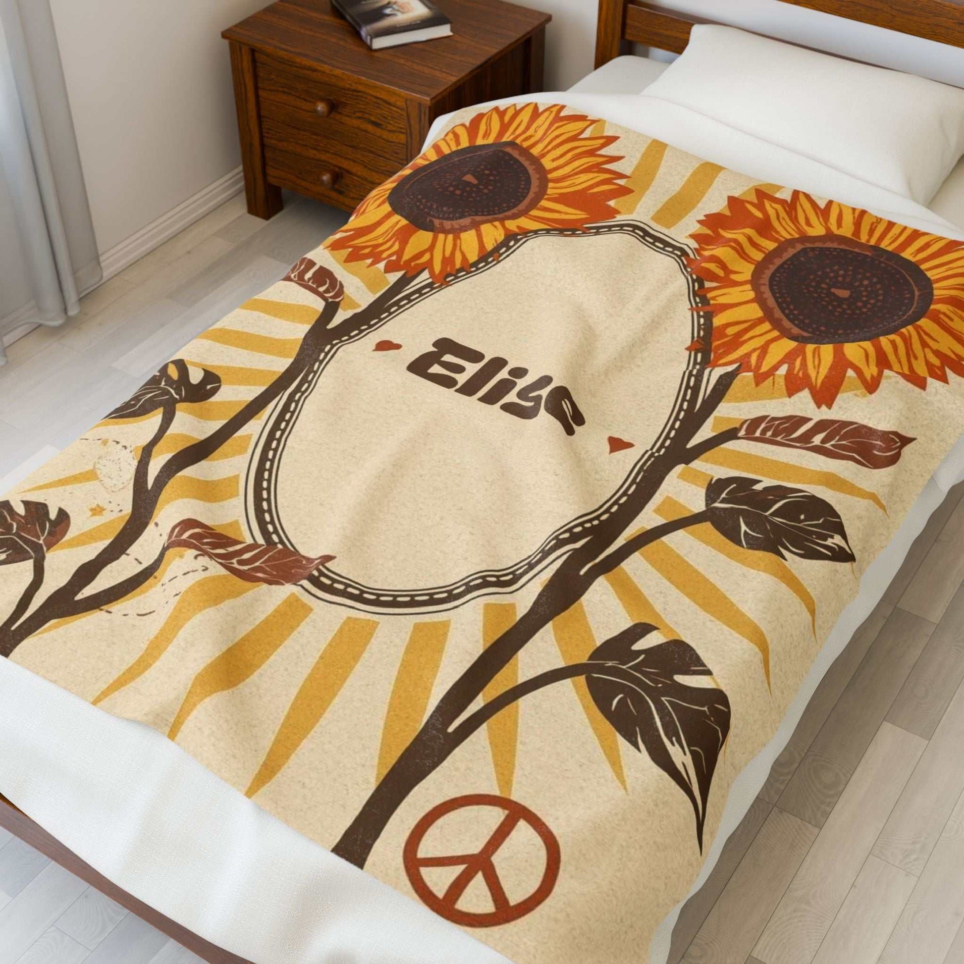 Personalized velveteen plush blanket with sunflower and peace sign design on bed