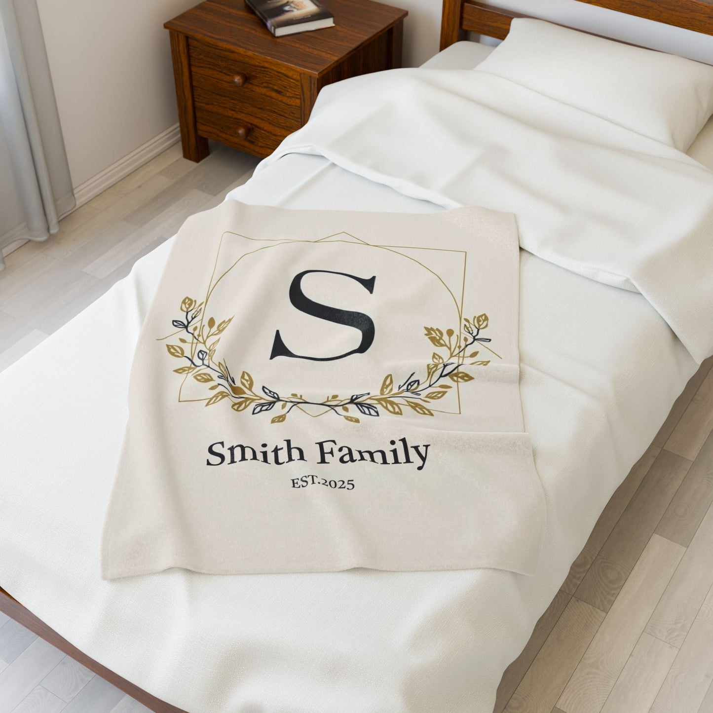 Personalized family monogram fleece blanket with custom name and established date on bed