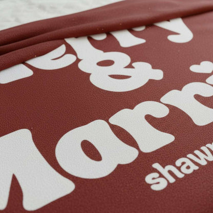Personalized Christmas blanket with "Merry & Married" text in retro white on red fleece, customizable with couple's names and wedding year.