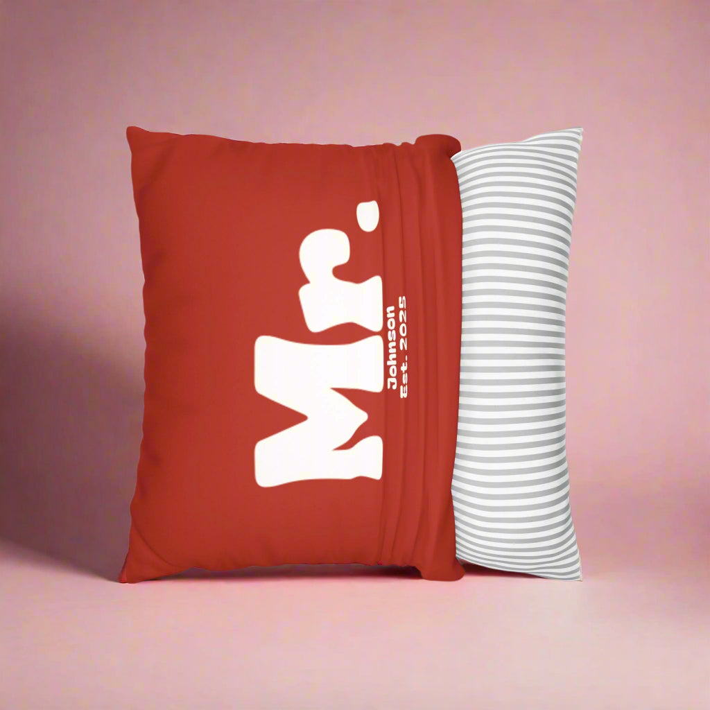 Red pillow with 'Mr' logo and white striped pillow on a white background