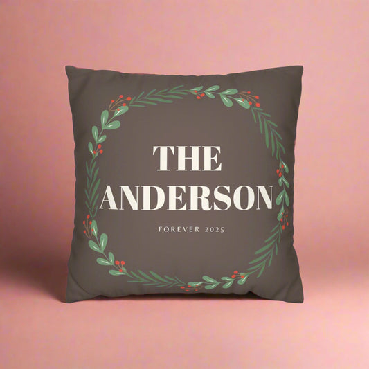 Decorative pillow with 'The Anderson' text and floral design on a brown background