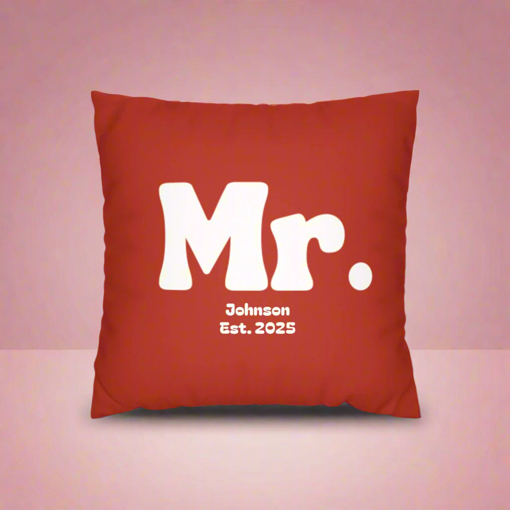 Red pillow with 'Mr. Johnson Est. 2025' text on a white background