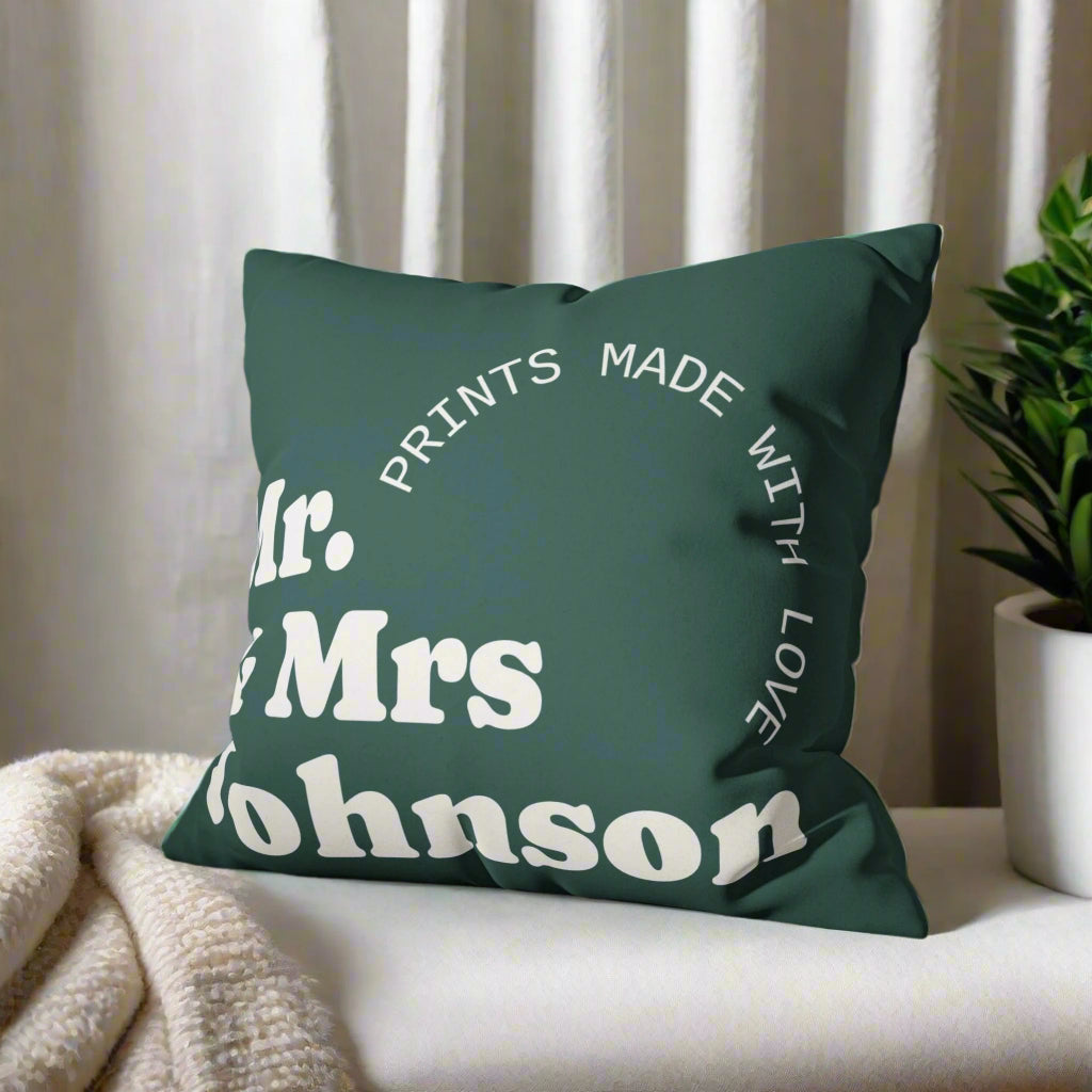 Green pillow with personalized text on a gray couch