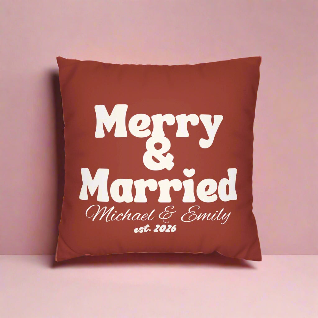 Red pillow with 'Merry Married' text and a white striped pillow on a white background