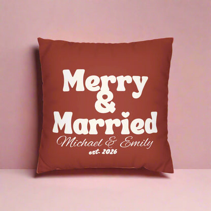 Red pillow with 'Merry Married' text and a white striped pillow on a white background