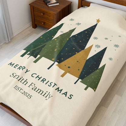 Personalized Christmas family tree fleece blanket with custom family name and holiday design on bed