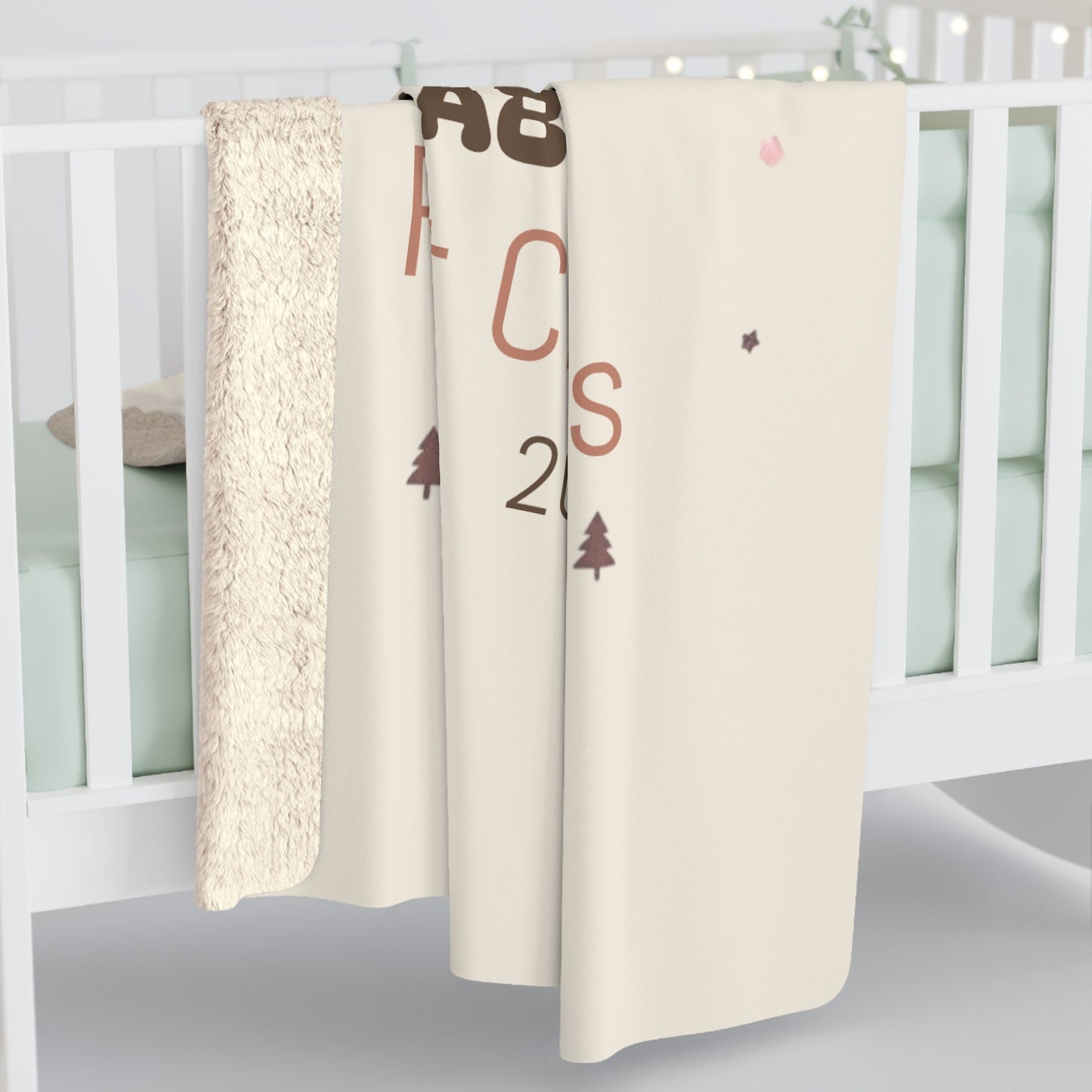 Personalized sherpa blanket with cozy fleece draped over white crib, perfect gift for moms and nursery decor