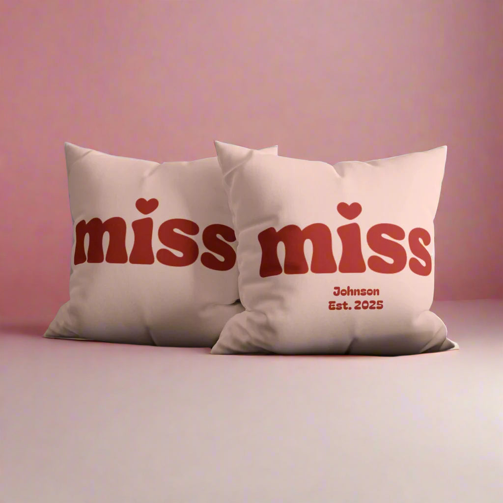 Pink pillow with red text 'miss' and 'Johnson Est. 2025' on a white background