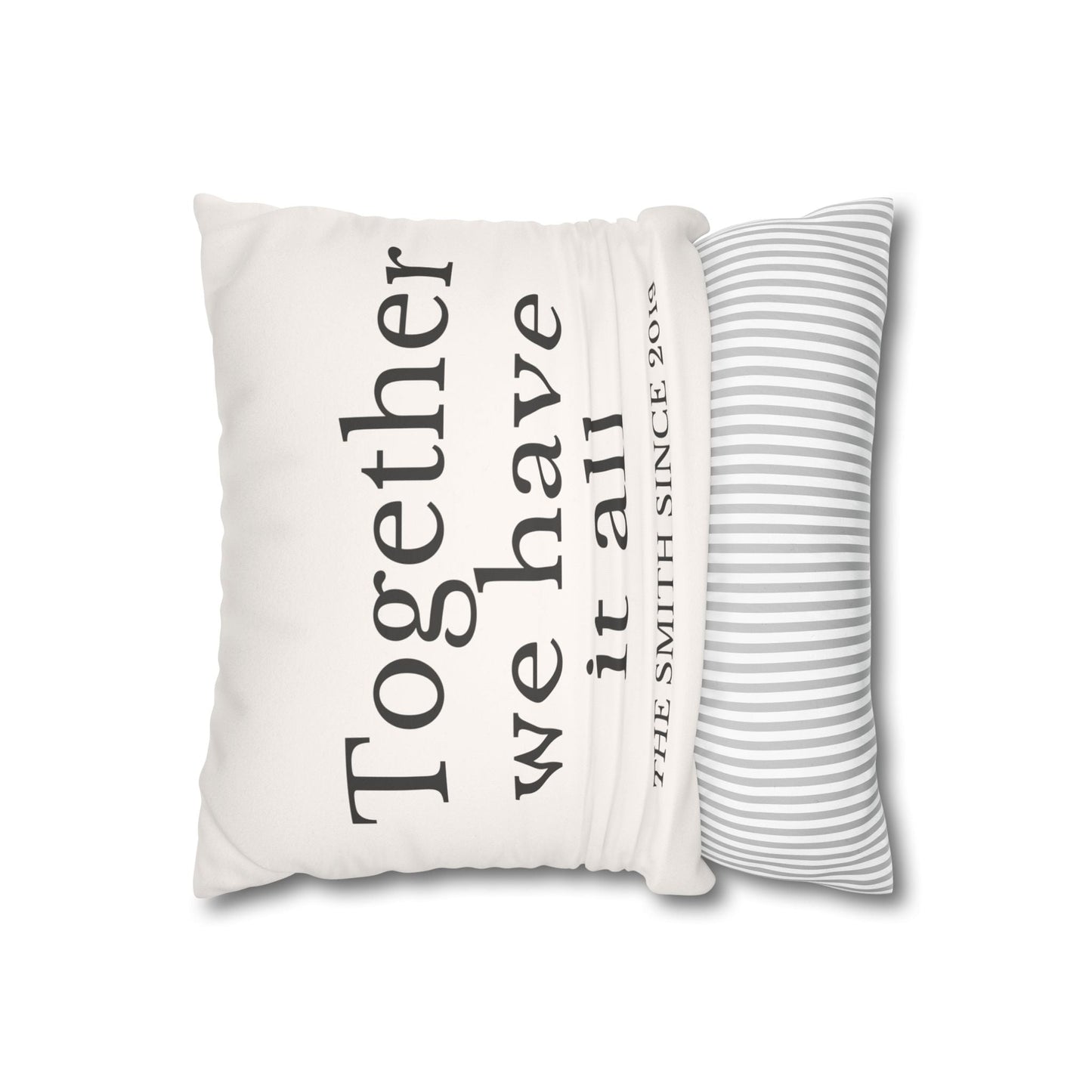 Personalized beige faux suede cushion cover with custom family name and striped back, housewarming and holiday gift