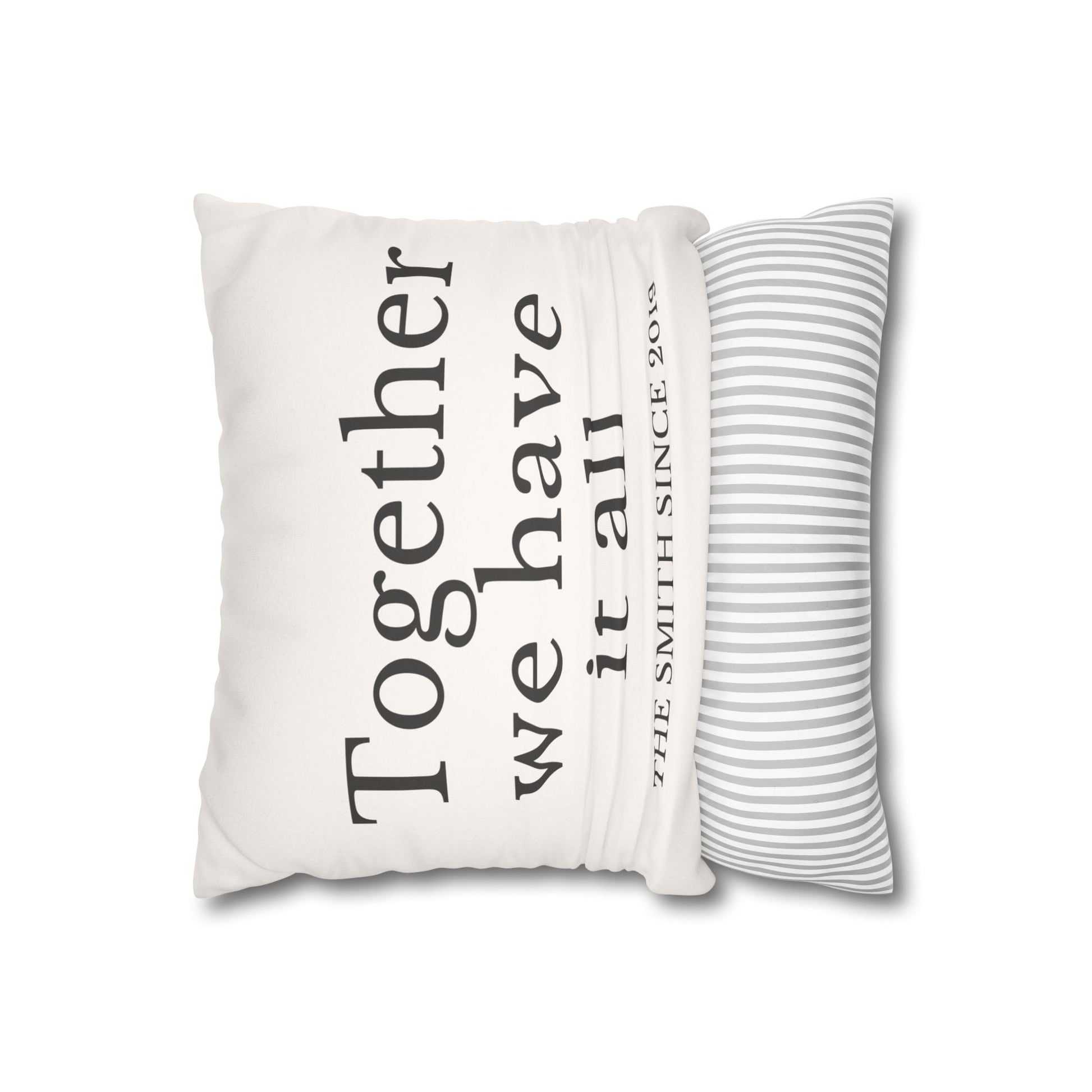 Personalized beige faux suede cushion cover with custom family name and striped back, housewarming and holiday gift