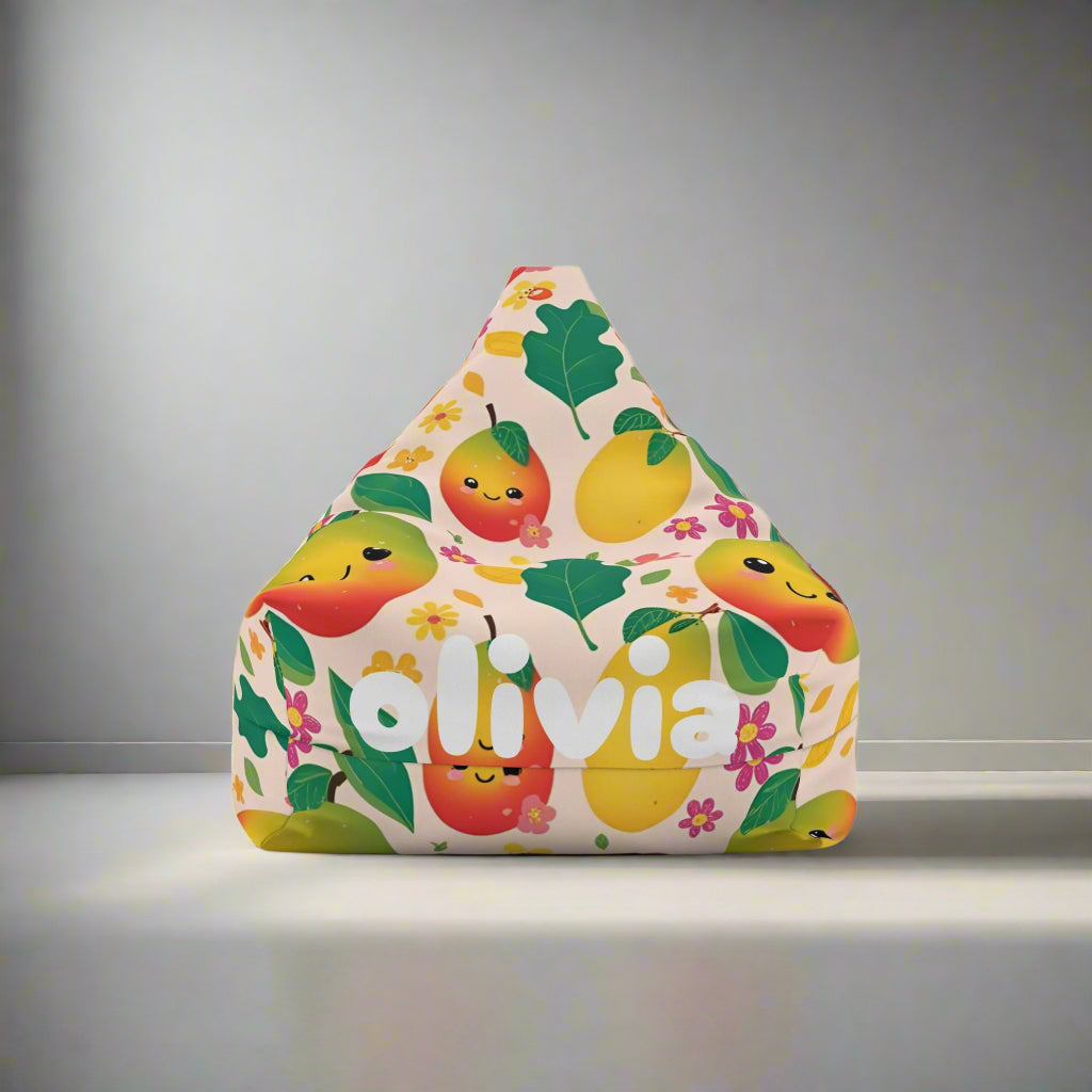 A child sitting on a bean bag chair with a mango fruit theme cover, featuring colorful mangoes and leaves design.