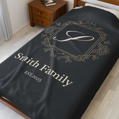 Personalized couples fleece throw blanket with custom monogram and family name on black background