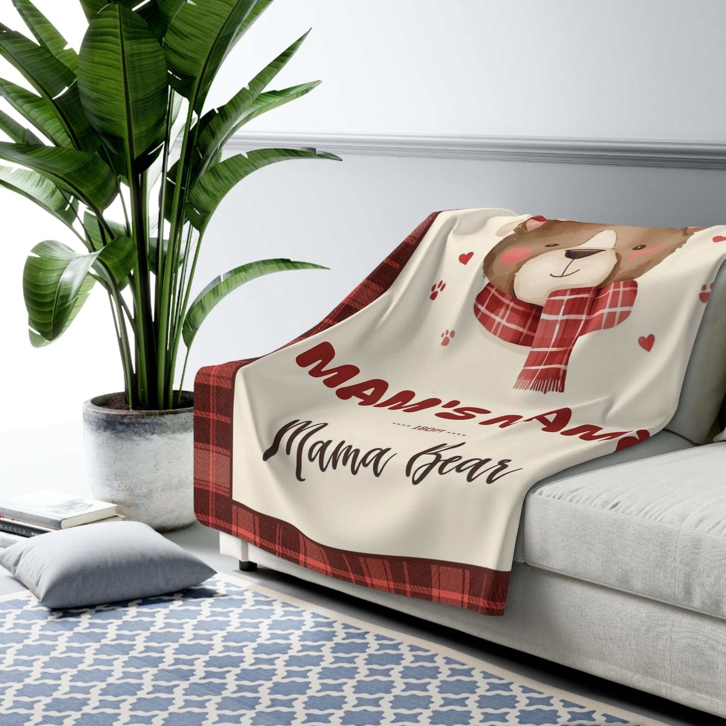 Personalized Mama Bear Christmas Blanket with buffalo plaid border and bear illustration on sofa