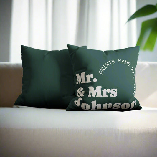 Green pillow with 'Mr. & Mrs. Johnson' text on a gray couch.
