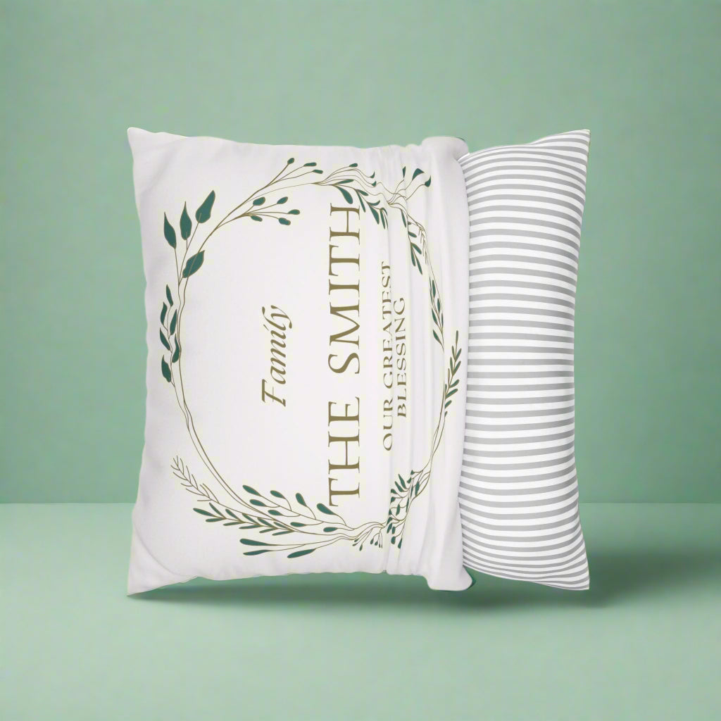 Decorative pillow with 'Family: The Smith, Our Greatest Blessing' text on a green background