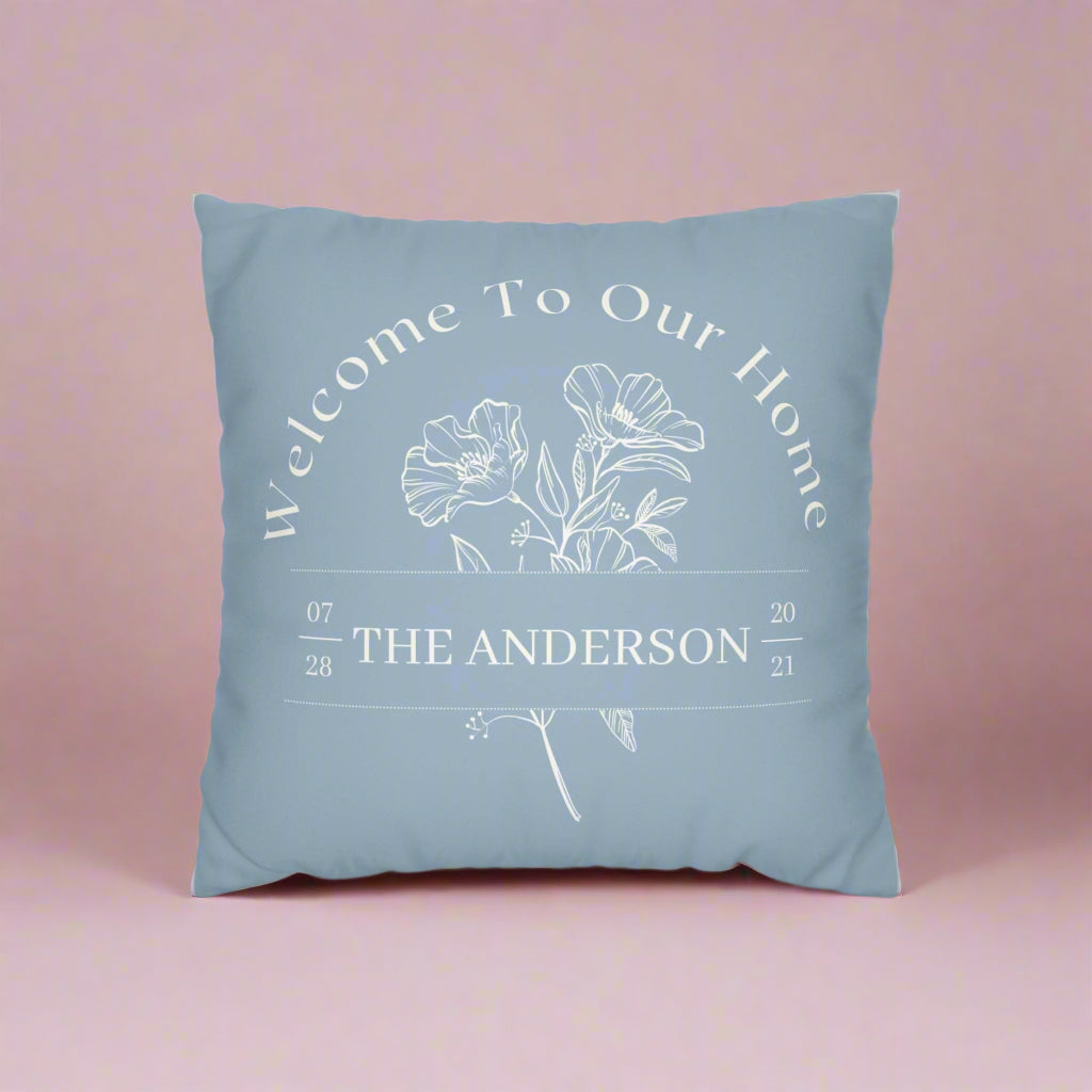 Blue pillow with floral design and text on a white background