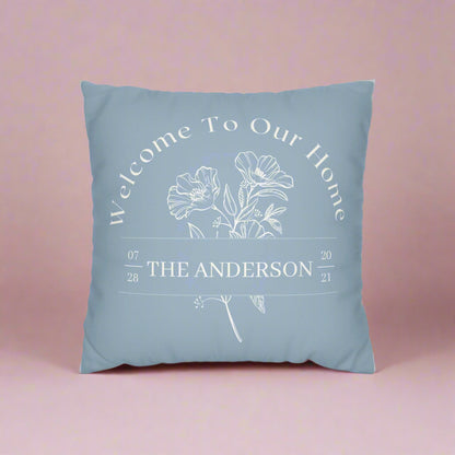 Blue pillow with floral design and text on a white background