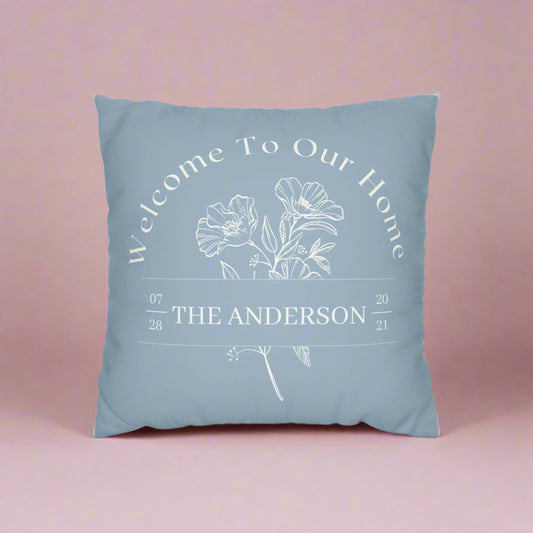 Blue pillow with floral design and text on a white background
