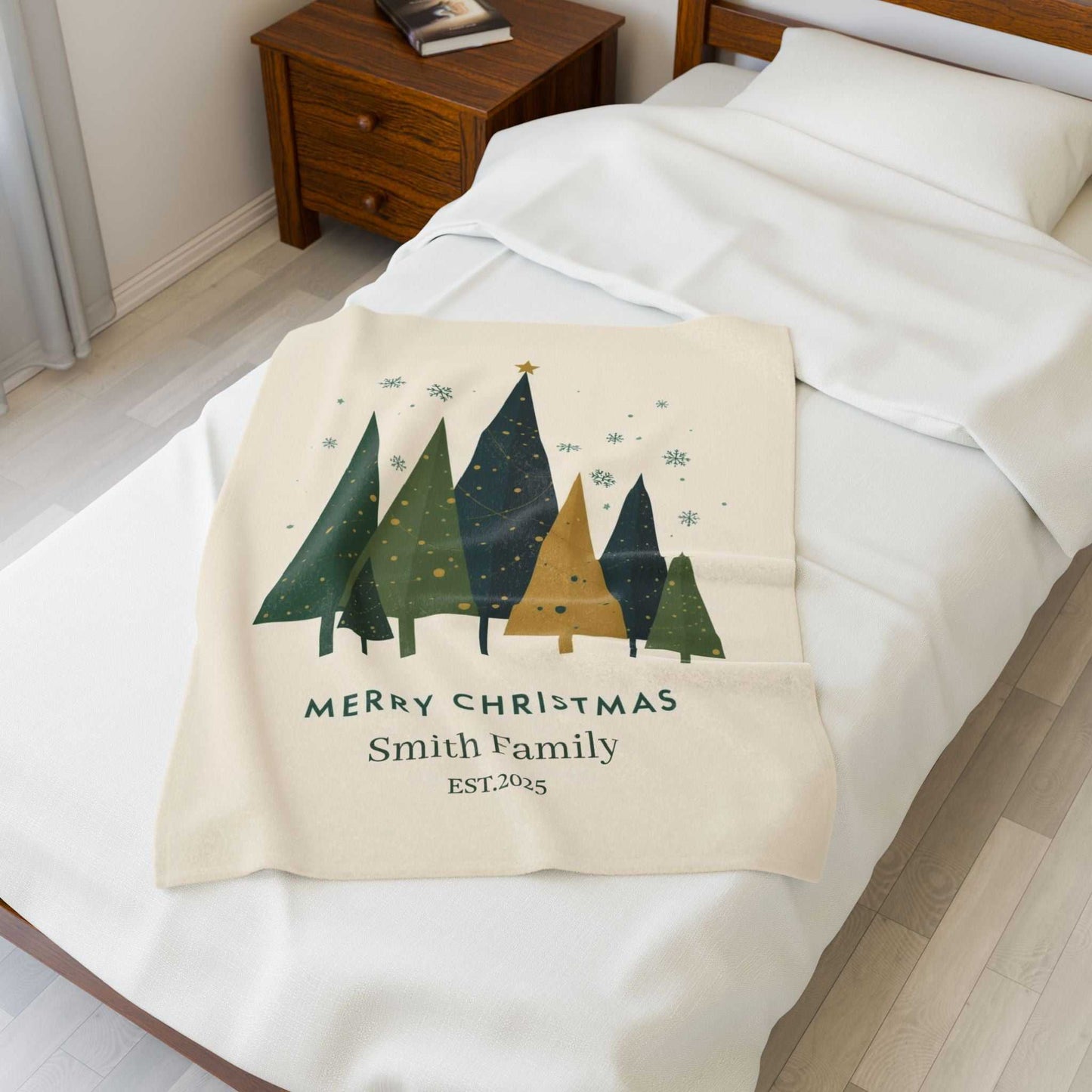 Personalized Christmas family tree fleece blanket with custom family name and holiday design on a bed