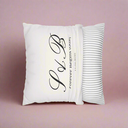 White pillow with black text and a striped pillow on a white background
