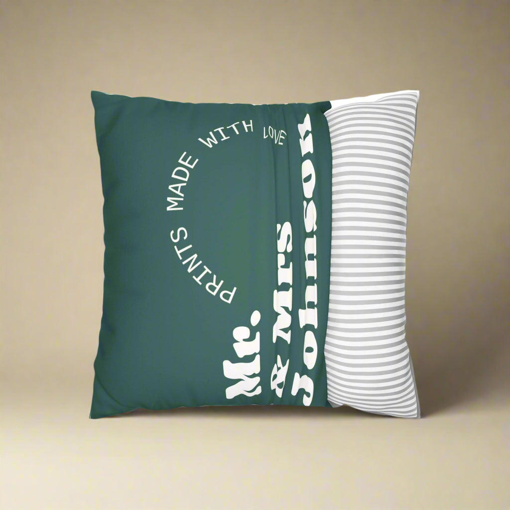 Green pillow with text and a white pillow with stripes on a white background