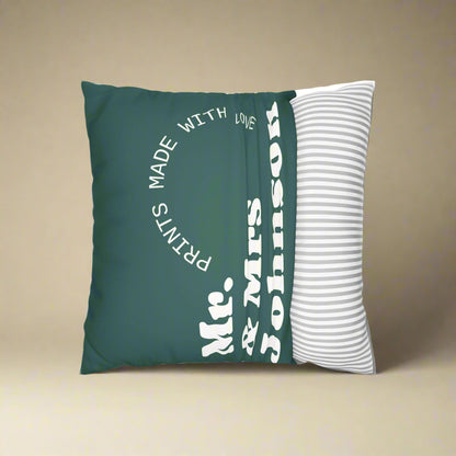 Green pillow with text and a white pillow with stripes on a white background