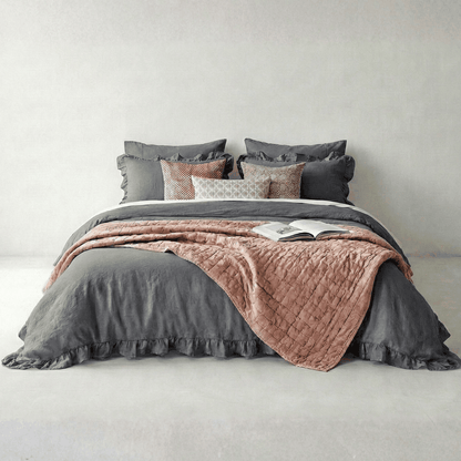 Dark grey rustic farmhouse ruffled duvet cover set on bed with textured trim and cozy decor