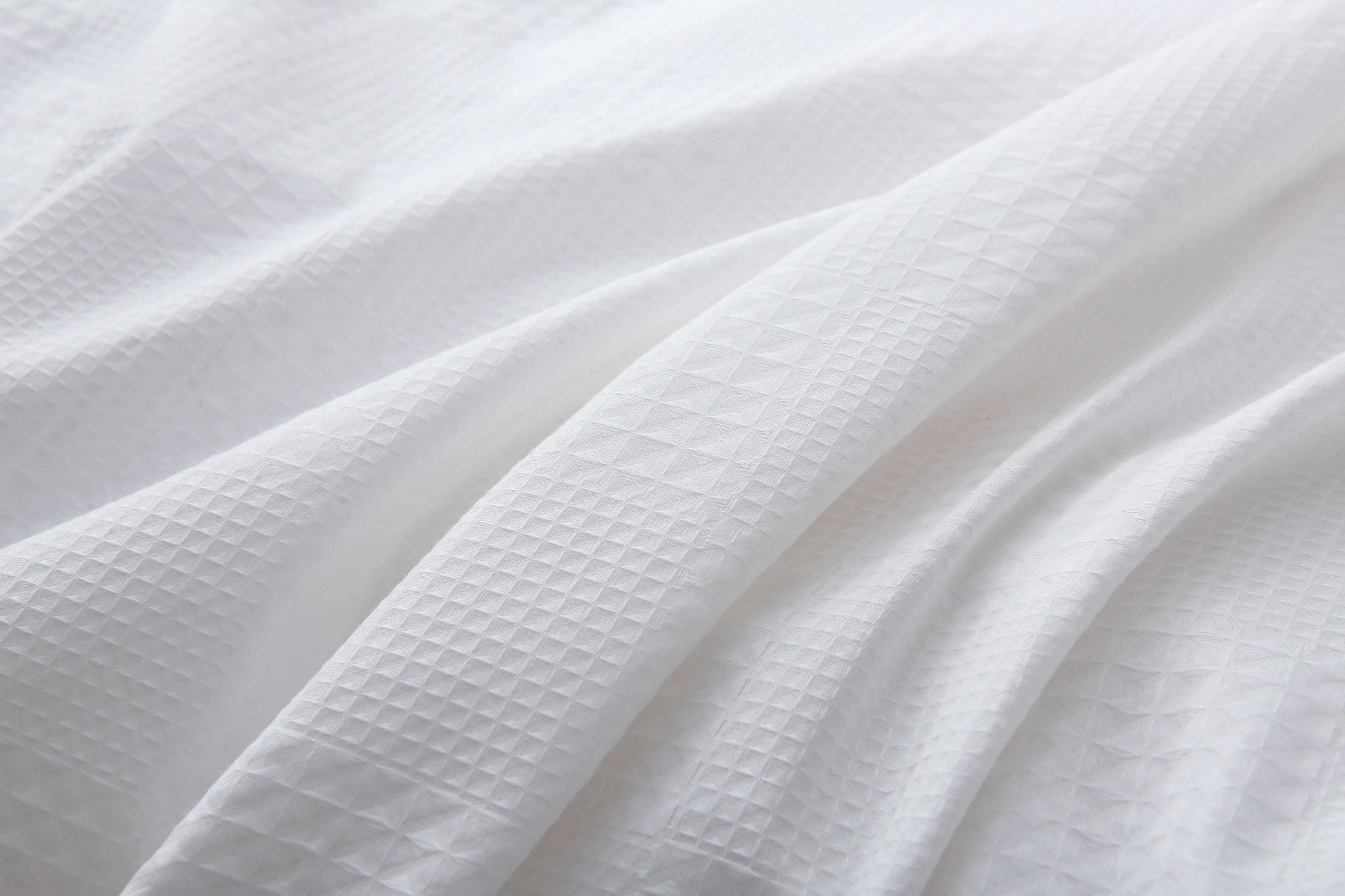 White duvet cover set with subtle waffle texture and black trim.