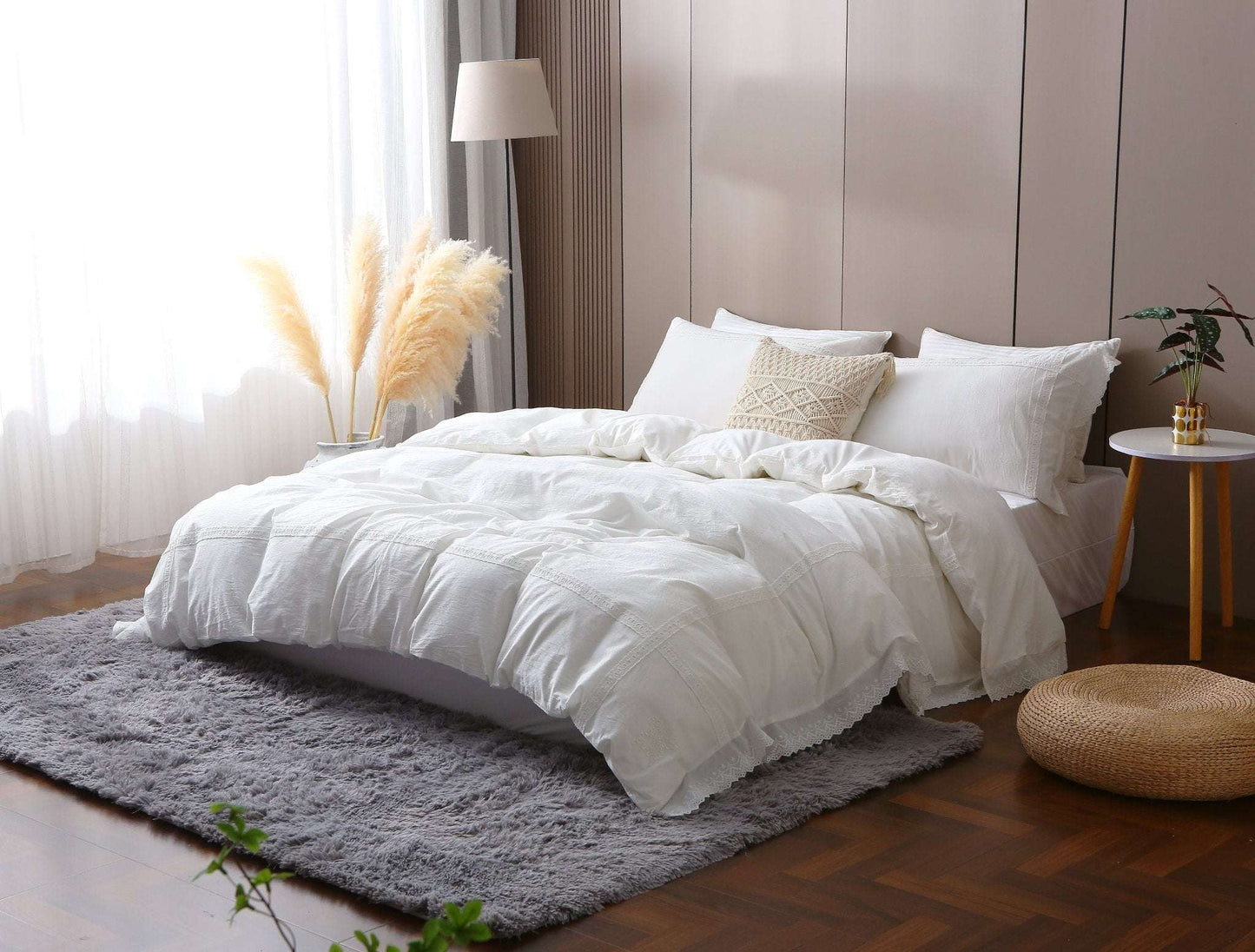 Modern farmhouse duvet cover with white lace trim on bed.