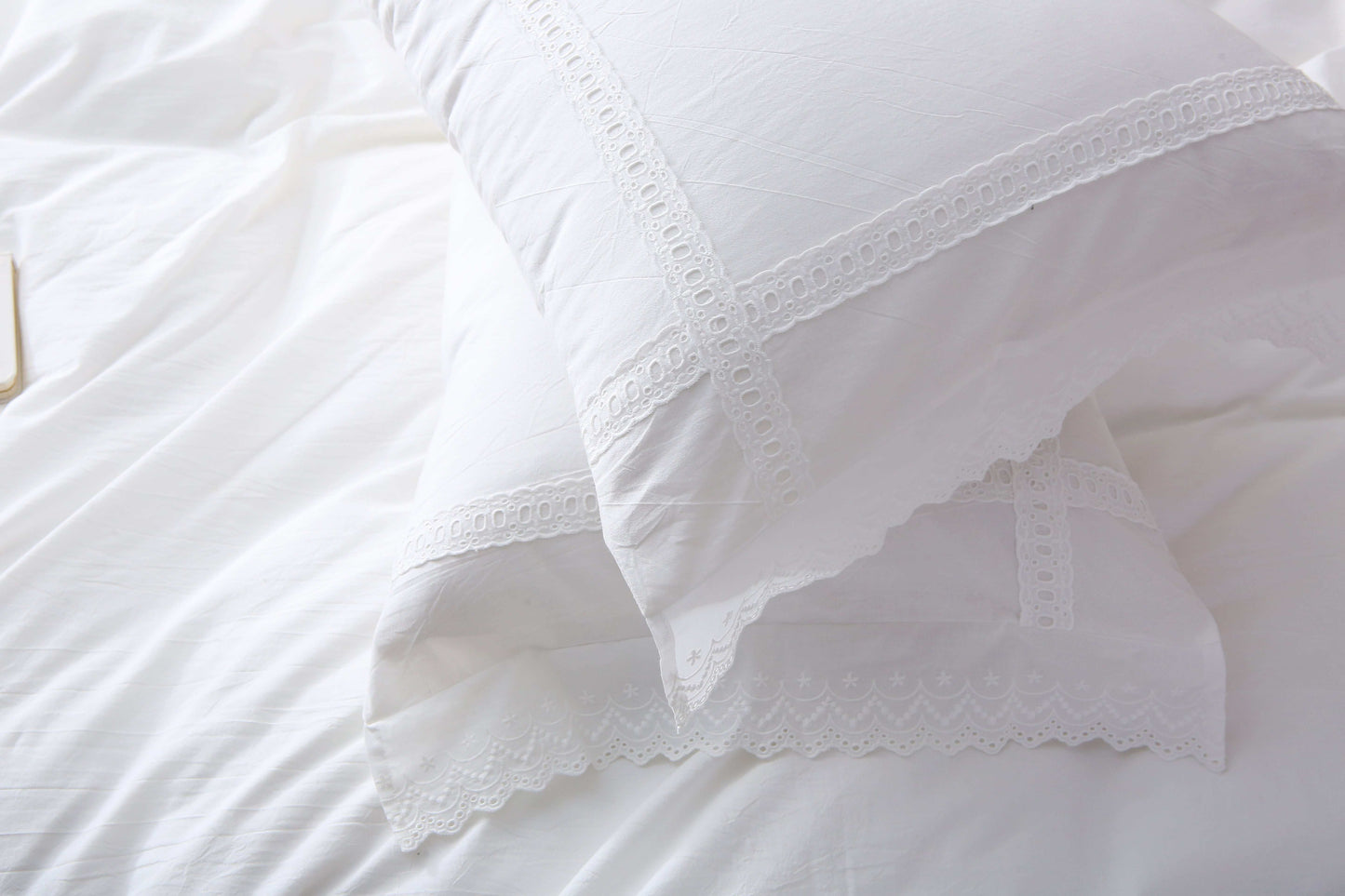 White duvet cover set with lace trim on bed, modern farmhouse style.