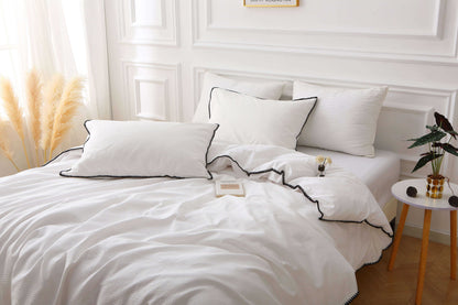 Elegant white duvet set with black trim, waffle texture, stylish bedding for modern bedrooms.