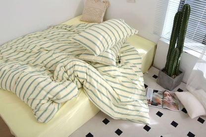 Green Stripe Bedding Set in premium washed cotton on yellow bed.