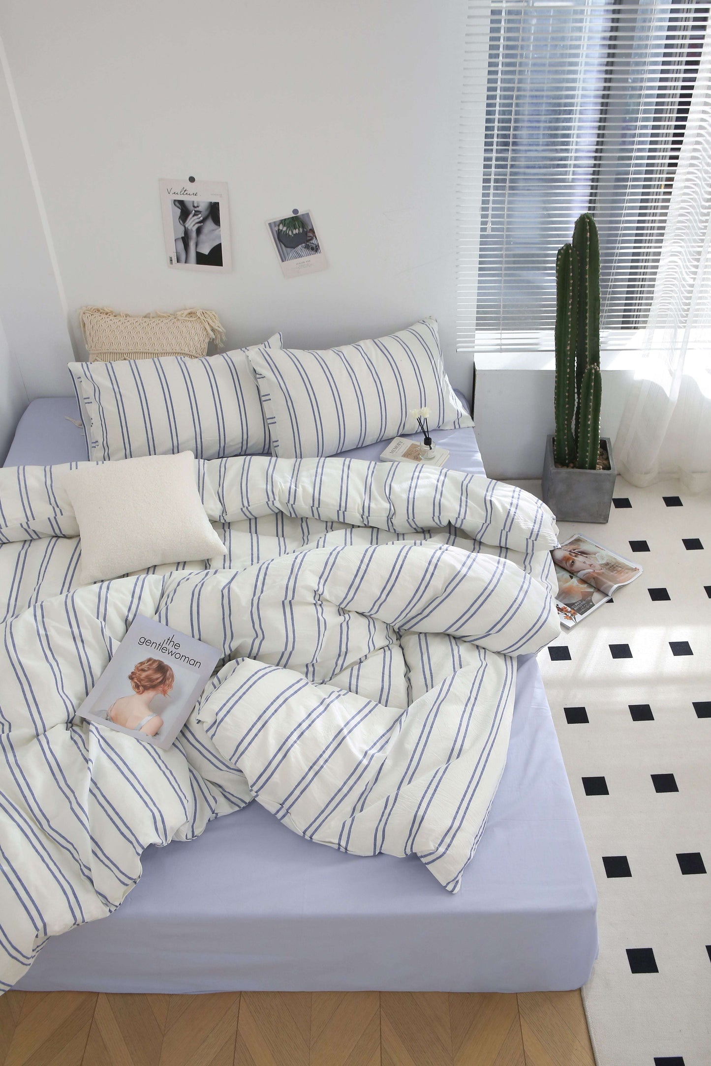 Blue Stripe Washed Cotton Bedding Set with duvet cover, sheets, and pillowcases on a bed.