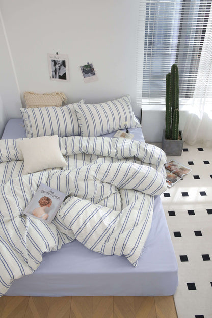 Blue Stripe Washed Cotton Bedding Set with duvet cover, sheets, and pillowcases on a bed.