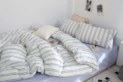 Blue Stripe Washed Cotton Bedding Set on bed with pillows and duvet cover.