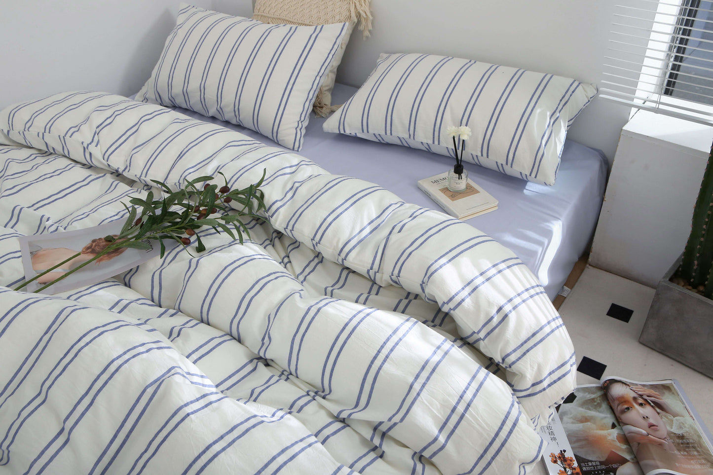 Blue striped bedding set with duvet cover, bed sheet, and pillowcases in soft washed cotton.