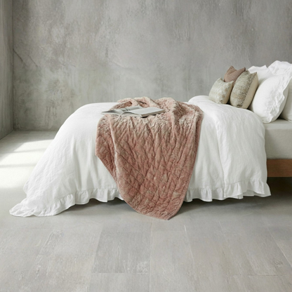 Minimalist white farmhouse bedroom decor with textured ruffled bedding